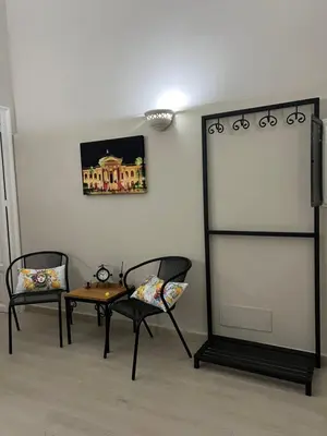a room with two chairs and a table and a screen at GDM central apartment Palermo in Palermo