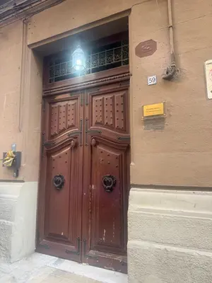 a large wooden door on the side of a building at La Piccola Formica Home in Palermo