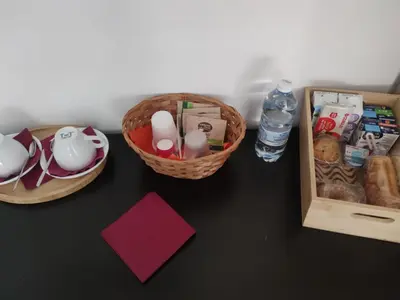 a table with baskets of food and a bottle of water at Villa Fragi in Cinisi