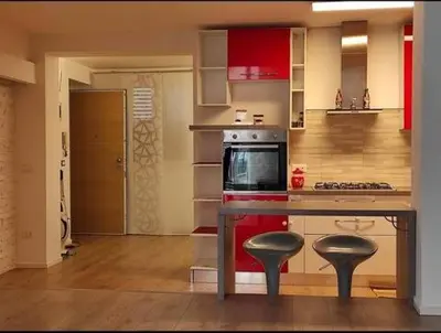a kitchen with a counter and two stools in it at Prince Suite Palermo in Palermo
