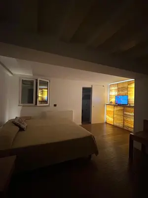 a bedroom with a bed and a television in it at Prince Suite Palermo in Palermo
