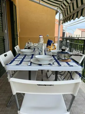 a white table with plates and dishes on it at Casa Vacanze Isabella in Campofelice di Roccella
