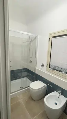 a bathroom with a shower and a toilet and a sink at Zohra in Castellammare del Golfo