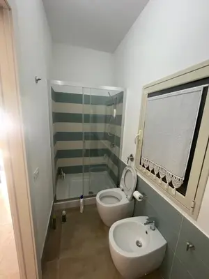 a bathroom with a toilet and a glass shower at Zohra in Castellammare del Golfo