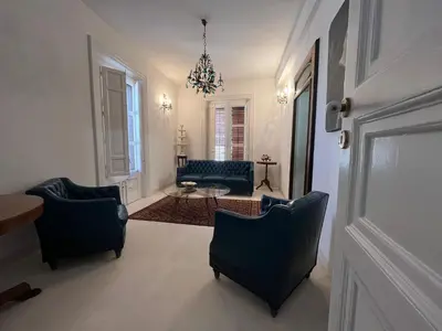 a living room with two chairs and a table at Palazzo Triolo - Dimora di Charme in Corleone