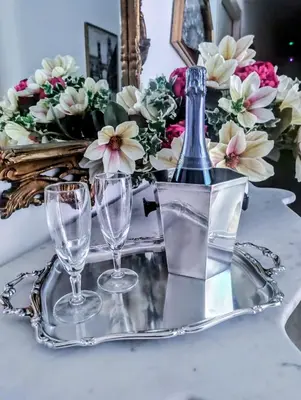 a silver tray with a bottle and glasses on it at LE CAMERE DI VIA MECCIO in Palermo