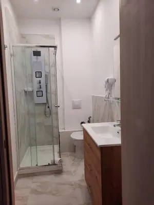 a bathroom with a shower and a sink and a toilet at LE CAMERE DI VIA MECCIO in Palermo