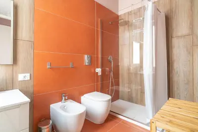 a bathroom with a toilet and a shower at B&B Handy Palermo in Palermo
