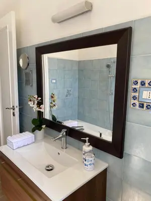a bathroom with a sink and a mirror at Casa Graziusa in Palermo