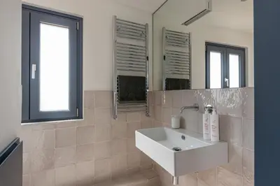 a bathroom with a white sink and a mirror at Porta di Castro Design Apartment with Terrace by Wonderful Italy in Palermo