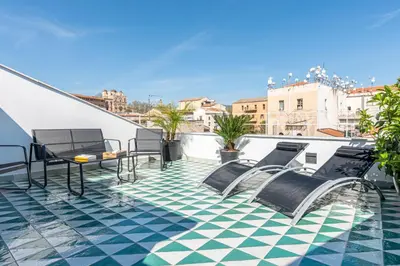 a balcony with chairs and a tile floor at Porta di Castro Design Apartment with Terrace by Wonderful Italy in Palermo