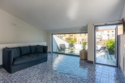 a living room with a couch and a balcony at Porta di Castro Design Apartment with Terrace by Wonderful Italy in Palermo