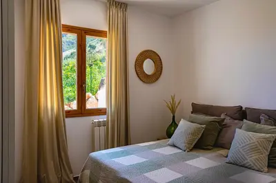 a bedroom with a bed with a window and a mirror at Villa Bellacosa con Piscina Privata vista mare in Castellammare del Golfo