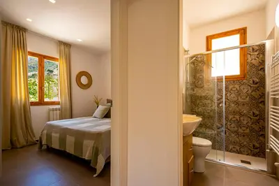 a bedroom with a bed and a sink and a toilet at Villa Bellacosa con Piscina Privata vista mare in Castellammare del Golfo