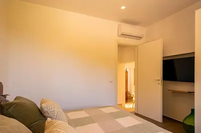a living room with a couch and a flat screen tv at Villa Bellacosa con Piscina Privata vista mare in Castellammare del Golfo