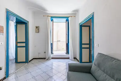 a living room with a couch and a window at Piazza Pretoria & Quattro Canti Roomy Flats with Balconies in Palermo