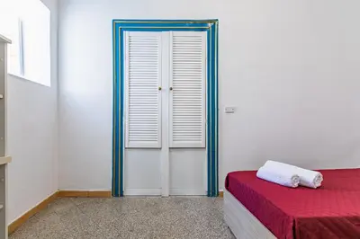 a room with a bed and a window and a door at Piazza Pretoria & Quattro Canti Roomy Flats with Balconies in Palermo