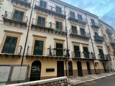 a tall building with balconies on the side of it at Guest House Colonna in Palermo