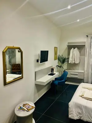 a room with a bedroom with a mirror and a bed at Guest House Colonna in Palermo