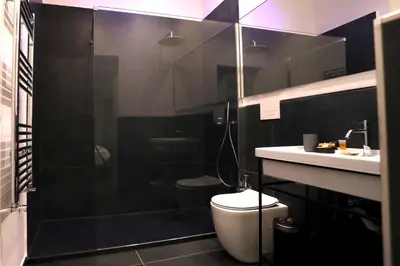a bathroom with a shower and a toilet and a sink at Guest House Colonna in Palermo