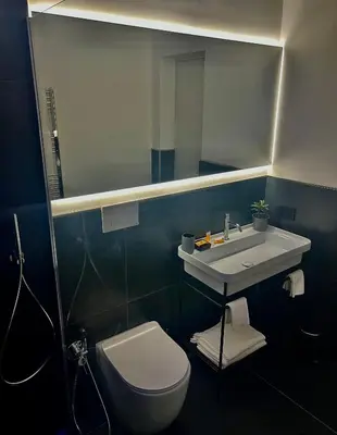 a bathroom with a sink and a toilet and a mirror at Guest House Colonna in Palermo