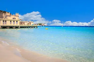 a view of a beach with a building in the water at Energy Home in Palermo