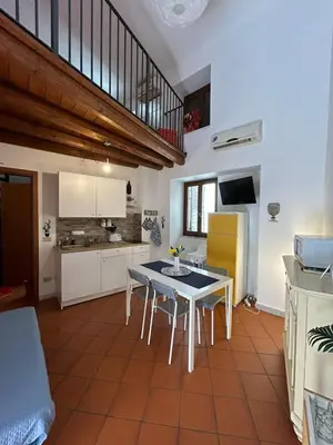 a kitchen with a table and chairs in a room at Vucciria's house centro storico in Palermo