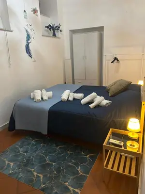 a bedroom with two beds with white towels on them at Vucciria's house centro storico in Palermo
