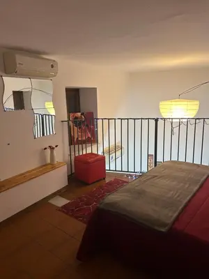 a bedroom with a bed and a balcony at Vucciria's house centro storico in Palermo