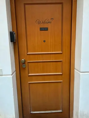 a wooden door with a welcome sign on it at Vucciria's house centro storico in Palermo