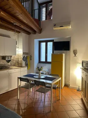 a kitchen with a table and chairs in a room at Vucciria's house centro storico in Palermo