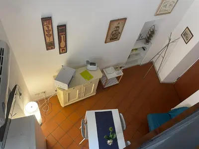 an overhead view of a living room with a table and a staircase at Vucciria's house centro storico in Palermo