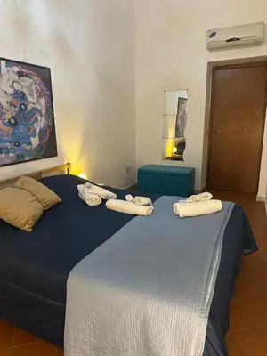 a bedroom with two beds with towels on them at Vucciria's house centro storico in Palermo