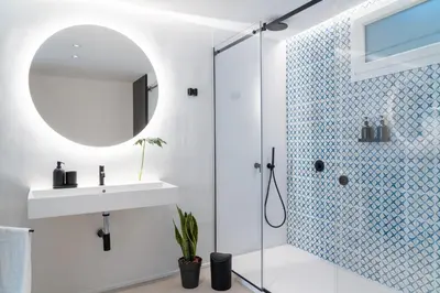 a bathroom with a shower and a sink and a mirror at Eligius Luxury Apartments in Palermo