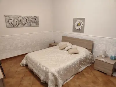 a bedroom with a bed with two pillows on it at Casa Milù in Palermo