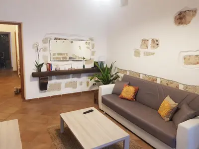 a living room with a couch and a table at Casa Milù in Palermo