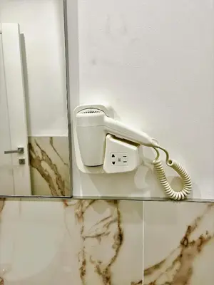 a white phone sitting on a counter in a bathroom at wood & white home in Palermo