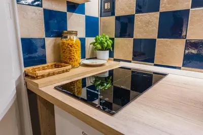 a kitchen with a counter top with a counter sidx sidx sidx at Casa Madì in Palermo