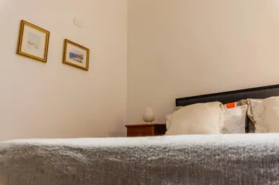 a bedroom with a bed and two pictures on the wall at Casa Madì in Palermo