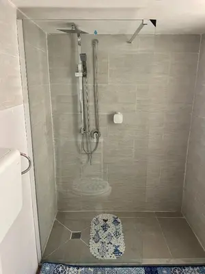 a shower with a glass door in a bathroom at Ninni Mondello House in Mondello