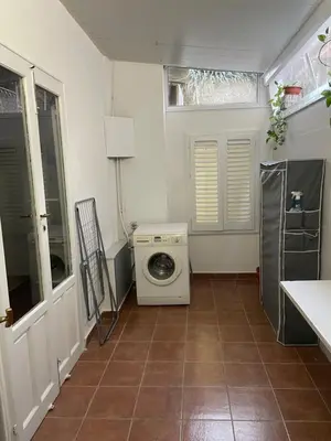 a laundry room with a washing machine in it at Ninni Mondello House in Mondello