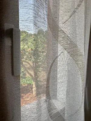 a window with a view of a tree at La Villa degli Ulivi - Apartments in Castellammare del Golfo