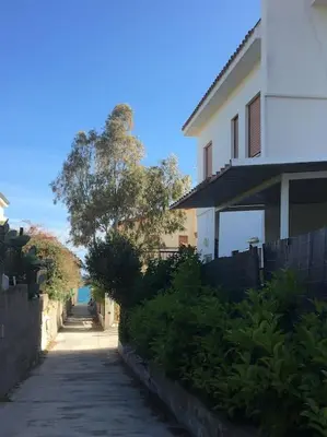 a walkway next to a house with a fence at Sea Air - Aria di Mare in Casteldaccia