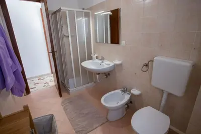 a bathroom with a toilet and a sink at Sea Air - Aria di Mare in Casteldaccia