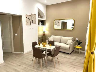 a living room with a table and a couch at Sikelia Apartment Centro in Palermo