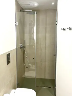 a glass shower in a bathroom with a toilet at Sikelia Apartment Centro in Palermo