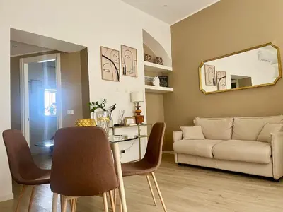 a living room with a table and a couch at Sikelia Apartment Centro in Palermo