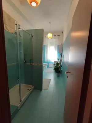 a bathroom with a shower and a glass shower stall at ALP House in Palermo