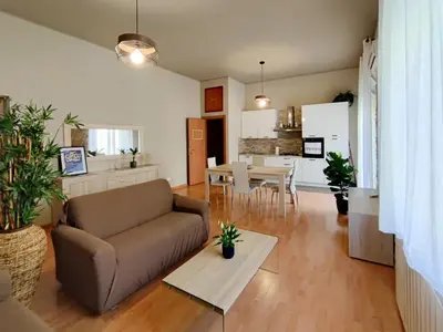 a living room with a couch and a table at ALP House in Palermo