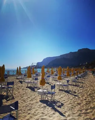 a bunch of chairs and umbrellas on a beach at Mondello Blue Sea in Mondello